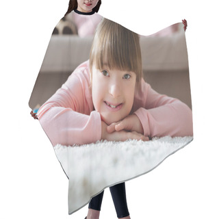 Personality  Smiling Kid With Down Syndrome Lying On Floor Hair Cutting Cape