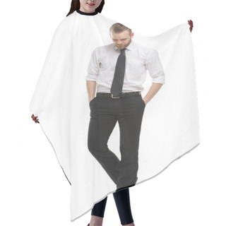 Personality  A Young Man With A Beard In His Daily Shirt Stands Tall And Holds His Hands In His Trouser Pockets, Isolated On A White Background. Hair Cutting Cape
