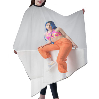 Personality  Urban Fashion, Tattooed Woman With Blue Hair Posing In Colorful Clothes Near White Cubes On Grey Background, Full Length, Individualism, Modern Style, Vibrant Color, Young Model  Hair Cutting Cape