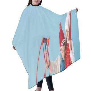 Personality  Horizontal Image Of Children In Winter Outfit Holding Skis And Sleight While Hugging Isolated On Blue  Hair Cutting Cape