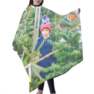 Personality  Adorable Little Smiling Kid Boy Holding Christmas Tree On Market. Happy Healthy Child In Winter Fashion Clothes Choosing And Buying Big Xmas Tree In Outdoor Shop. Family, Tradition, Celebration. Hair Cutting Cape