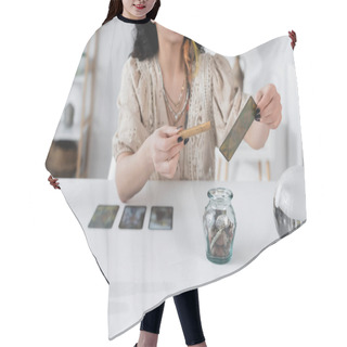 Personality  Cropped View Of Fortune Teller Holding Sage Stick And Tarot Card At Home  Hair Cutting Cape