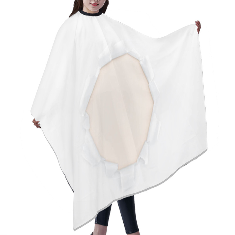 Personality  ripped hole in white textured paper on ivory background  hair cutting cape