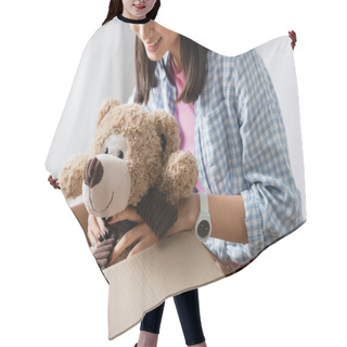 Personality  Cropped View Of Volunteer Smiling While Putting Soft Toy In Box In Charity Office  Hair Cutting Cape