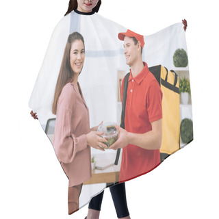 Personality  Businesswoman Smiling At Camera While Holding Container With Salad Near Delivery Man With Thermo Backpack In Office Hair Cutting Cape