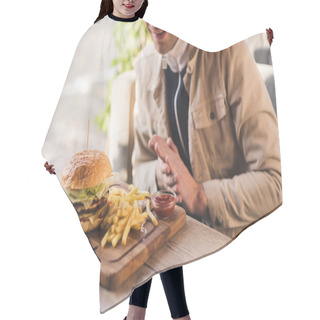 Personality  Cropped View Of Cheerful Man Looking At Tasty Burger And French Fries On Cutting Board In Cafe Hair Cutting Cape