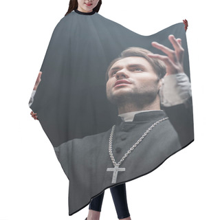Personality  Low Angle View Of Young Serious Catholic Priest Praying With Raised Hands Isolated On Black Hair Cutting Cape