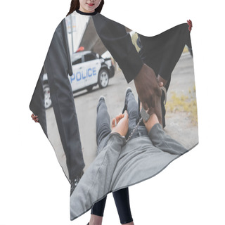 Personality  Cropped View Of African American Policeman Handcuffing Hooded Offender Lying On Street On Blurred Background Outdoors Hair Cutting Cape