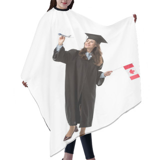 Personality  Smiling Female Student In Academic Gown Holding Canadian Flag And Plane Model Isolated On White, Studying Abroad Concept Hair Cutting Cape