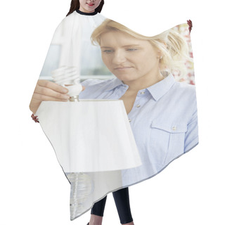 Personality  Woman Putting Low Energy Lightbulb Into Lamp At Home Hair Cutting Cape