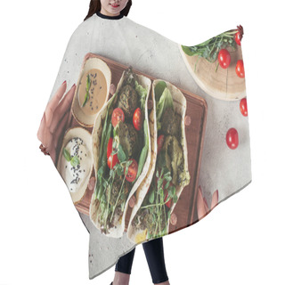 Personality  Cropped Shot Of Woman Holding Falafel With Tortillas, Cherry Tomatoes And Germinated Seeds Of Sunflower Served On Wooden Board On Grey Surface Hair Cutting Cape