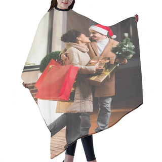 Personality  Happy Man In Santa Hat Holding Shopping Bags And Fir Near African American Girlfriend With Gift Boxes  Hair Cutting Cape