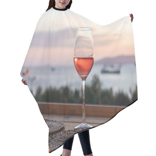 Personality  Single Glass Of Rose Wine Over Natural Background. Sea, Colorful Sky And Trees. Hair Cutting Cape
