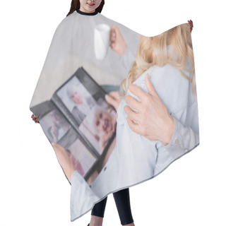 Personality  Cropped View Of Senior Mother With Cup Hugging Daughter With Blurred Photo Album  Hair Cutting Cape