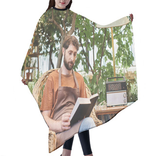 Personality  Handsome Bearded Gardener In Linen Apron Reading Book And Sitting Around Plants In Greenhouse Hair Cutting Cape