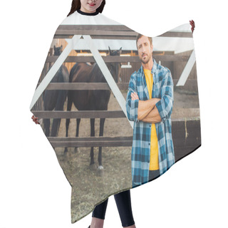 Personality  Farmer In Checkered Shirt Looking At Camera While Standing With Crossed Arms Near Corral With Horses Hair Cutting Cape