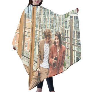 Personality  A Couple Shares A Moment With Laughter And Red Wine, Framed By Cityscape Views On A Wooden Balcony Hair Cutting Cape