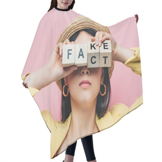 Personality  Asian Woman Holding Wooden Cubes In Front Of Face With Fake And Fact Lettering Isolated On Pink Hair Cutting Cape