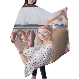 Personality  Smiling Fashion Designer Holding Templates In Showroom On Blurred Foreground Hair Cutting Cape