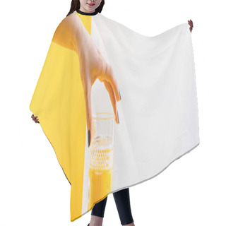 Personality  Cropped View Of Woman Holding Glass Of Fresh Delicious Yellow Smoothie On Grey And Yellow Background, Panoramic Shot Hair Cutting Cape