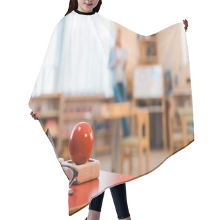 Personality  Selective Focus Of Wooden Game And Eyeglasses With Teacher At Background In Montessori Class Hair Cutting Cape