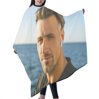 Personality  Close-up Portrait Of Adult Man With Wireless Earphones On Seashore Looking At Camera Hair Cutting Cape