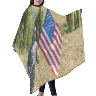 Personality  Panoramic Shot Of Handsome Military Man In Uniform And Cap Holding American Flag  Hair Cutting Cape