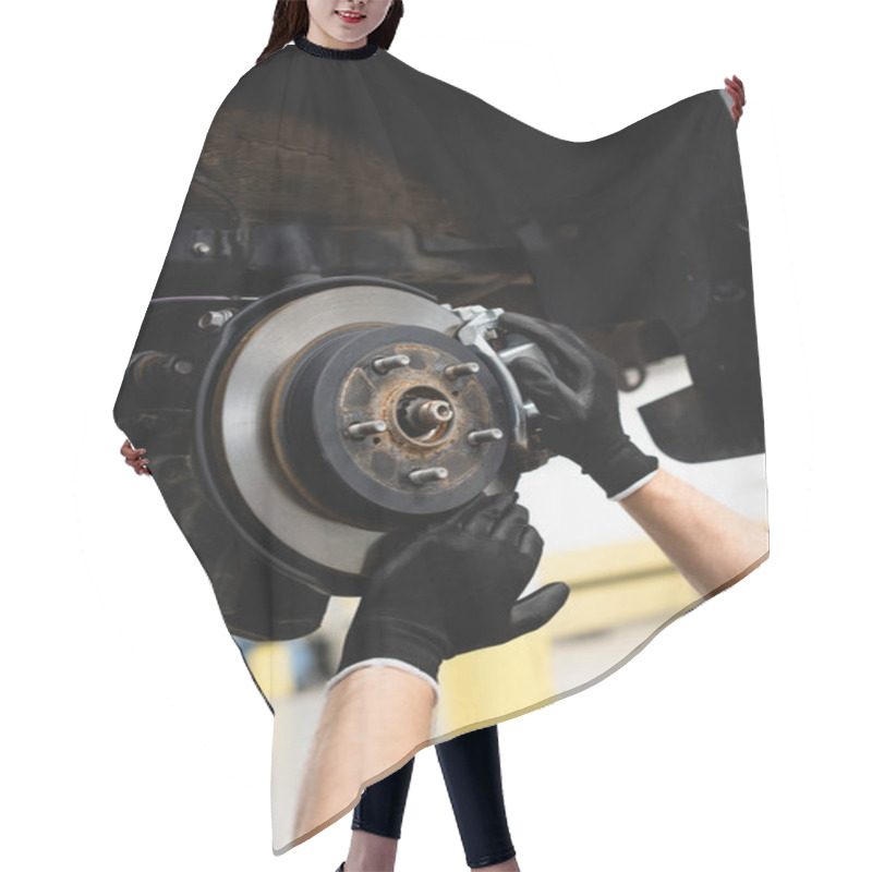 Personality  cropped view of mechanic in rubber gloves touching car brake and fixing vehicle  hair cutting cape