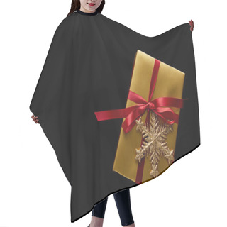Personality  Top View Of Shiny Golden Christmas Gift With Red Ribbon And Snowflake Isolated On Black Hair Cutting Cape