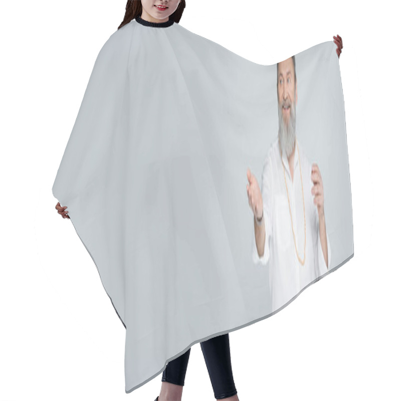 Personality  Smiling Spiritual Mentor Looking Away And Pointing With Hand Isolated On Grey, Banner Hair Cutting Cape