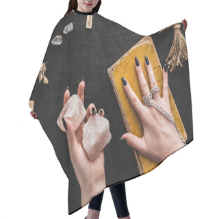 Personality  Top View Of Witch Holding Crystals And Touching Aged Book Of Dark Magic Near Voodoo Doll And Runes On Black  Hair Cutting Cape