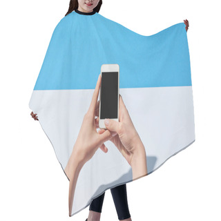 Personality  Cropped View Of Woman Using Smartphone With Blank Screen On White Desk And Blue Background Hair Cutting Cape