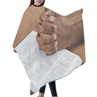 Personality  Cropped Shot Of African American Man Praying With Holy Bible On Wooden Table Hair Cutting Cape