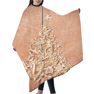 Personality  Simple Christmas Tree Arranged From Sawdust, Wood-chips On Wooden Background. Hair Cutting Cape