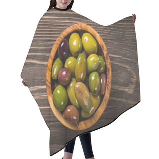 Personality  Black And Green Olives On Wooden Table. Hair Cutting Cape