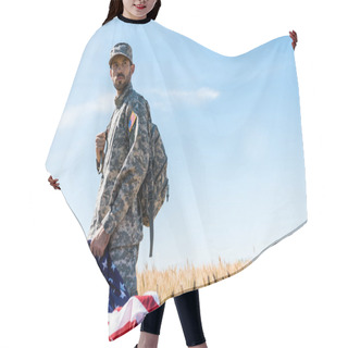 Personality  Selective Focus Of Soldier In Uniform Holding American Flag While Standing In Field  Hair Cutting Cape