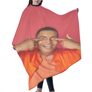 Personality  Cheerful African American Guy Obscuring Eyes With Fingers, Orange Shirt, Red Background Hair Cutting Cape