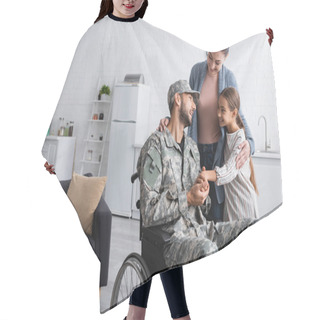 Personality  Smiling Kid Holding Hand Of Dad In Military Uniform In Wheelchair Near Mother At Home  Hair Cutting Cape