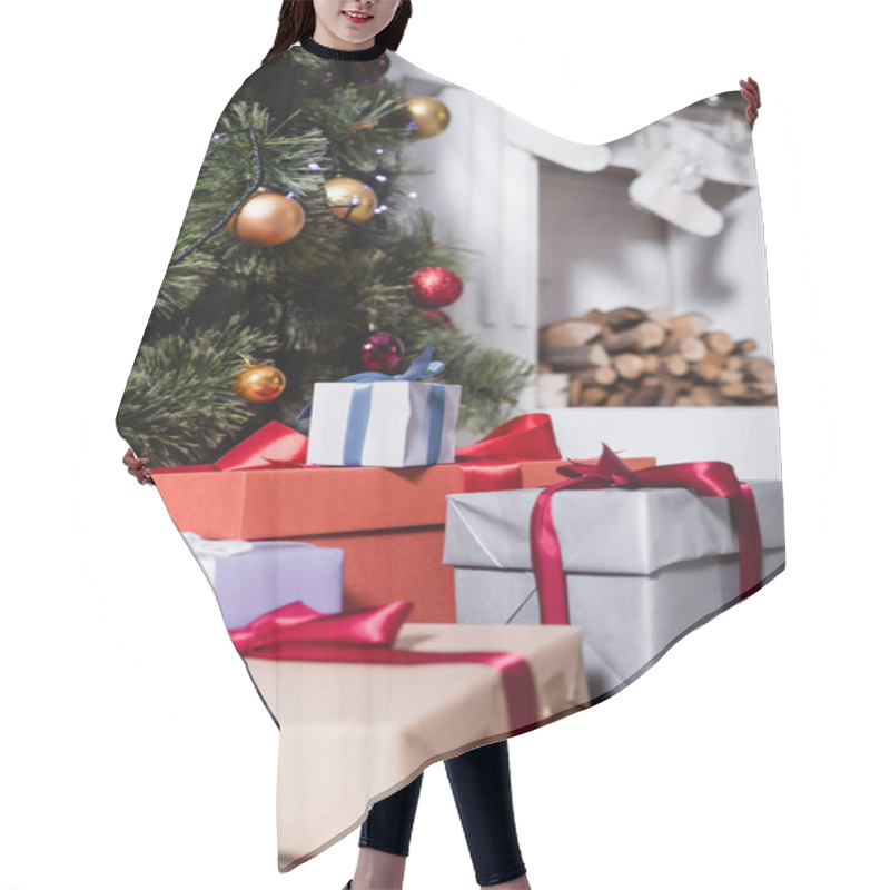 Personality  Selective focus of gift boxes near pine and fireplace with christmas stockings hair cutting cape