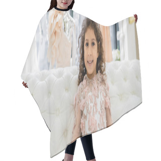 Personality  Happy Middle Eastern Girl With Curly Hair Sitting In Floral Dress On White Couch And Smiling Inside Of Luxurious Wedding Salon, Smiling Kid, Tulle Skirt, Blurred Background, Banner  Hair Cutting Cape