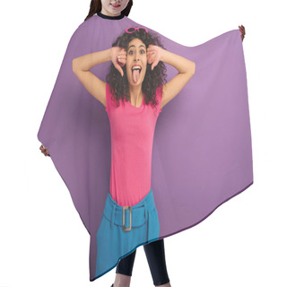 Personality  Cheerful Bi-racial Girl Sticking Out Tongue While Looking At Camera On Purple Background Hair Cutting Cape