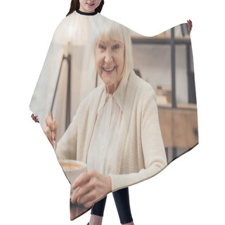 Personality  Smiling Senior Woman Sitting At Table And Eating Cream Soup At Home Hair Cutting Cape