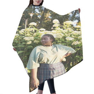 Personality  A Plus-size African American Woman Stands Confidently In Front Of A Bush With White Flowers, Embracing The Beauty Of Nature Around Her. Hair Cutting Cape