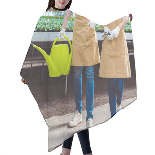 Personality  Close-up View Of Gardener With Rake And Watering Can Among Plants In Greenhouse Hair Cutting Cape