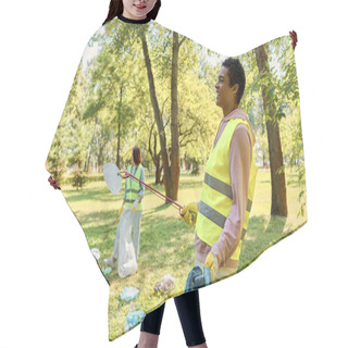 Personality  A Loving, Diverse Couple In Safety Vests And Gloves Clean Up A Park Together, Standing In The Lush Green Grass. Hair Cutting Cape