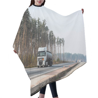 Personality  LVIV, UKRAINE - OCTOBER 23, 2019: Truck With Cistern And Daf Inscription Moving On Highway Along Trees Hair Cutting Cape