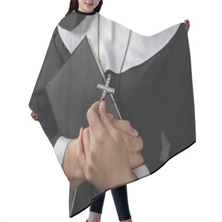 Personality  Young Nun In A Robe Holding  Bible And  Cross Against The Dark Wall. Close-up. Woman Hugging  Book Hair Cutting Cape