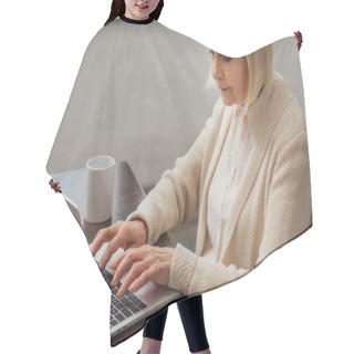 Personality  Senior Woman Sitting At Table And Typing On Laptop At Home Hair Cutting Cape