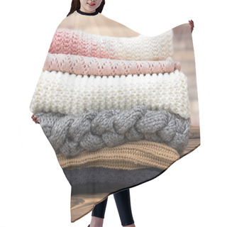 Personality  Winter Knitted Clothes Stack On Wooden Background. Hair Cutting Cape