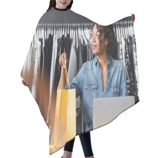 Personality  Curly African American Saleswoman Holding Yellow Paper Bag Near Gadgets On Sales Counter Desk Hair Cutting Cape